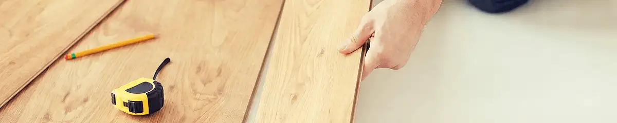 A professional installing wood flooring in Nashua, NH