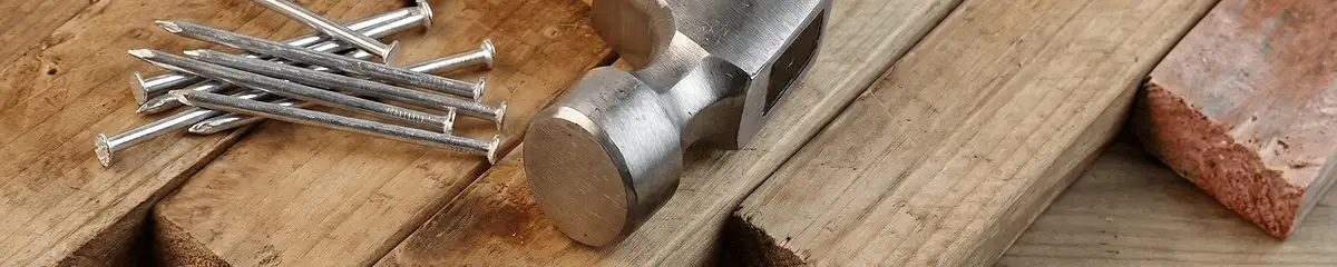 Hammer and nails on hardwood flooring boards in Nashua, NH
