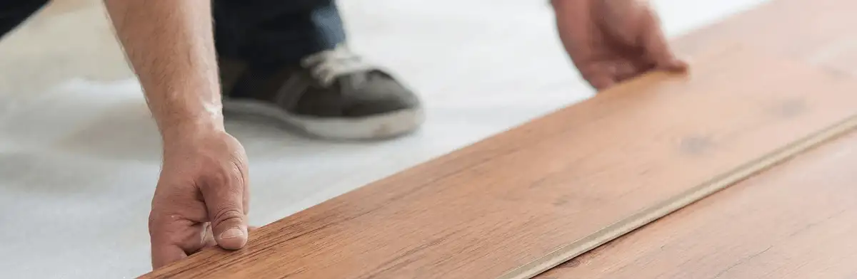 A professional installing laminate flooring in Nashua, NH