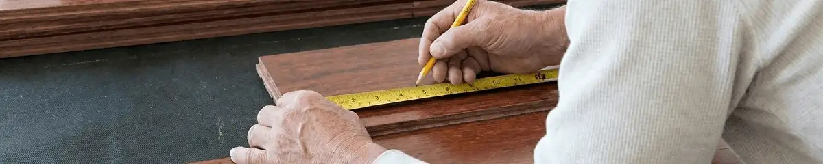 A professional installing wood flooring in Nashua, NH